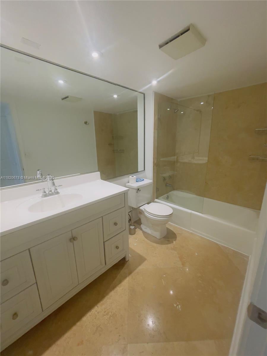 780 Northeast 69th Street, Unit 1507 Miami, FL 33138 - Photo 10 of 23 a bathroom with a double vanity sink toilet and shower