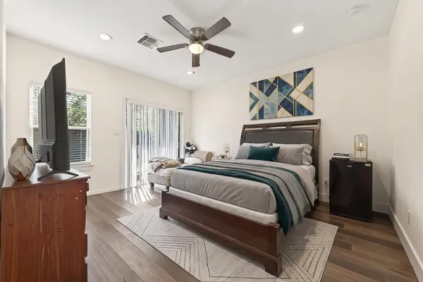 a bedroom with a bed and a flat screen tv