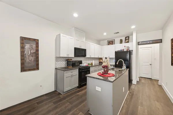 a open kitchen with sink refrigerator and stove