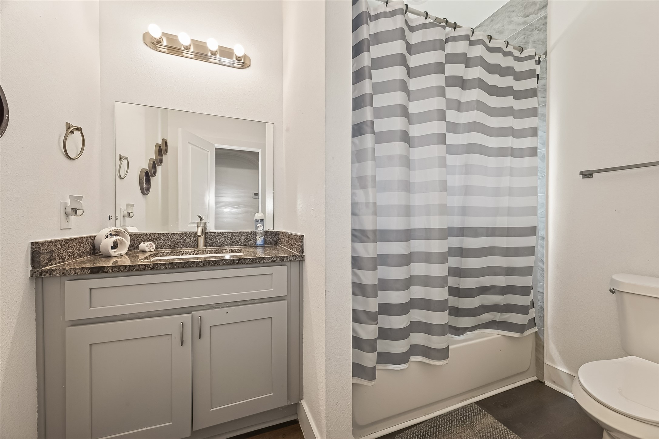 1035 Junell Street Houston, TX 77088 - Photo 8 of 14 a bathroom with a granite countertop sink a toilet and a mirror