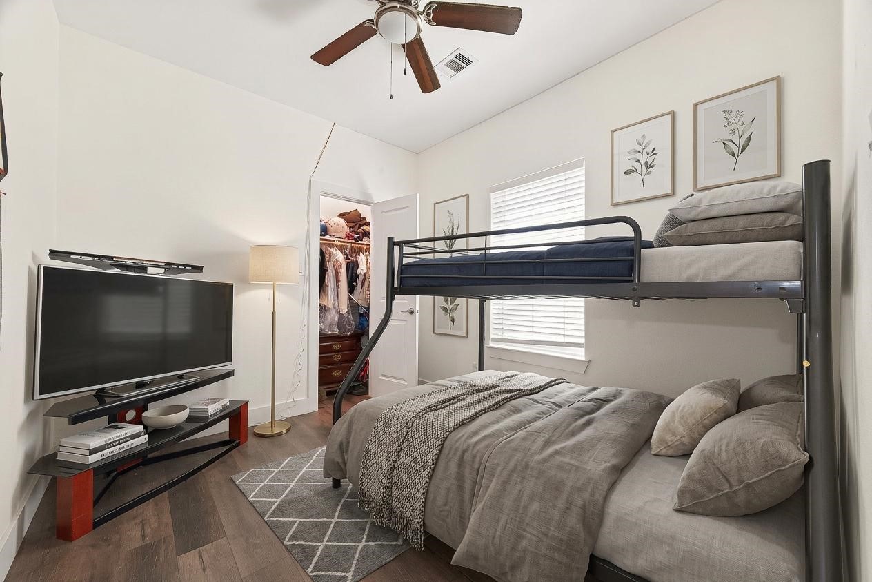 1035 Junell Street Houston, TX 77088 - Photo 9 of 14 a bedroom with a bed and a flat screen tv