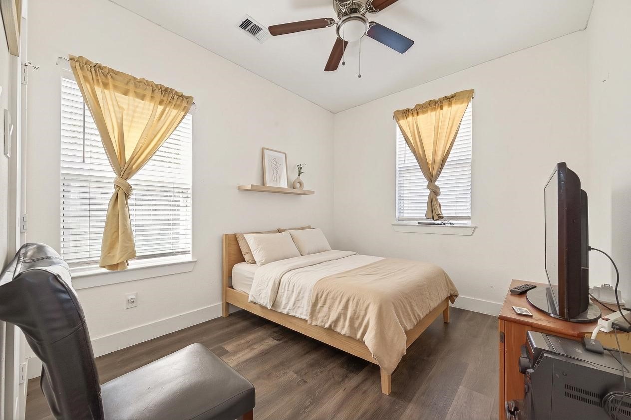 1035 Junell Street Houston, TX 77088 - Photo 10 of 14 a bedroom with a bed tv and a window