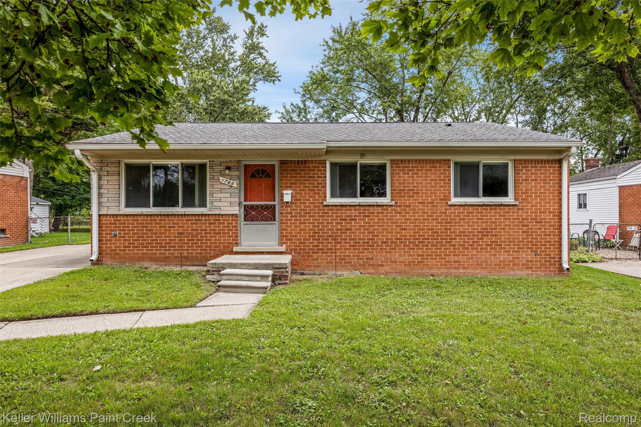 1766 Henry Ruff Road Garden City, MI 48135 - Photo 31 of 36 Brick exterior with stone accents, gray shingle roof, concrete walkway, and a concrete driveway
