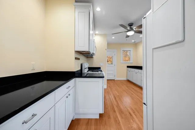 a kitchen with stainless steel appliances a sink and a refrigerator