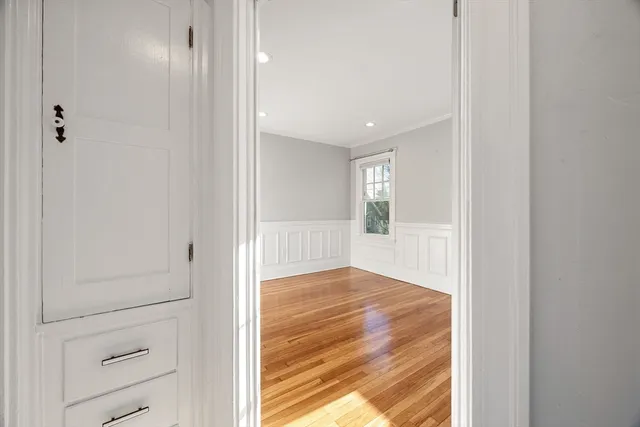 a view of a hallway with wooden floor