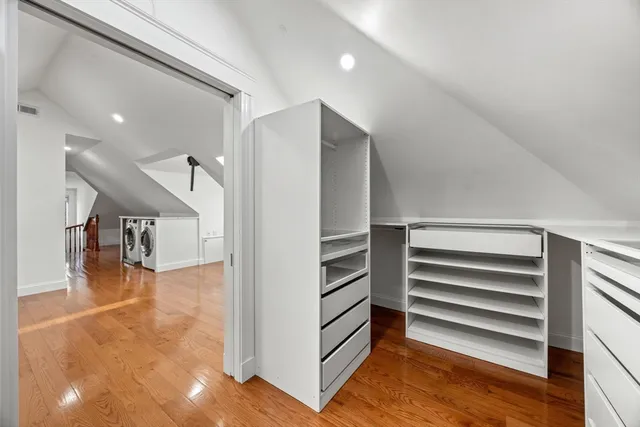 a view of entryway and hall with wooden floor