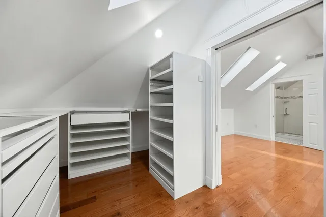 a view of walk in closet with empty racks