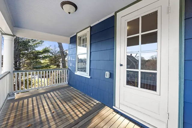 a view of a balcony with wooden floor