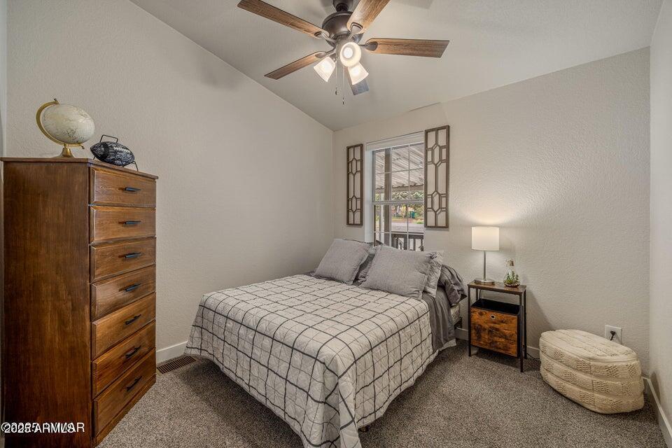 1590 Peterson Road Lakeside, AZ 85929 - Photo 11 of 41 a bedroom with a bed and a chandelier