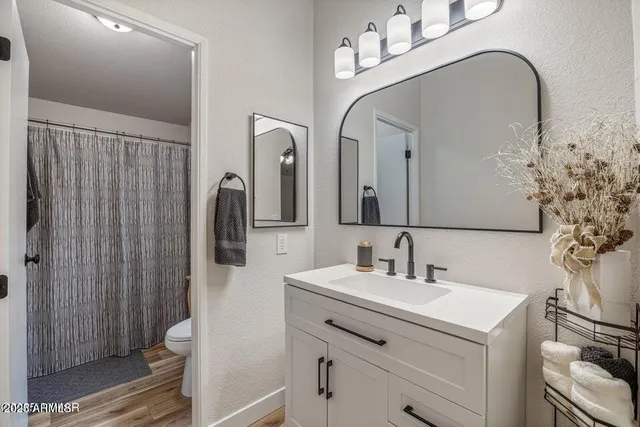 a bathroom with a double vanity sink mirror and shower