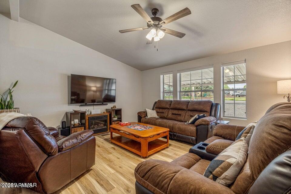 1590 Peterson Road Lakeside, AZ 85929 - Photo 2 of 41 a living room with furniture and a flat screen tv