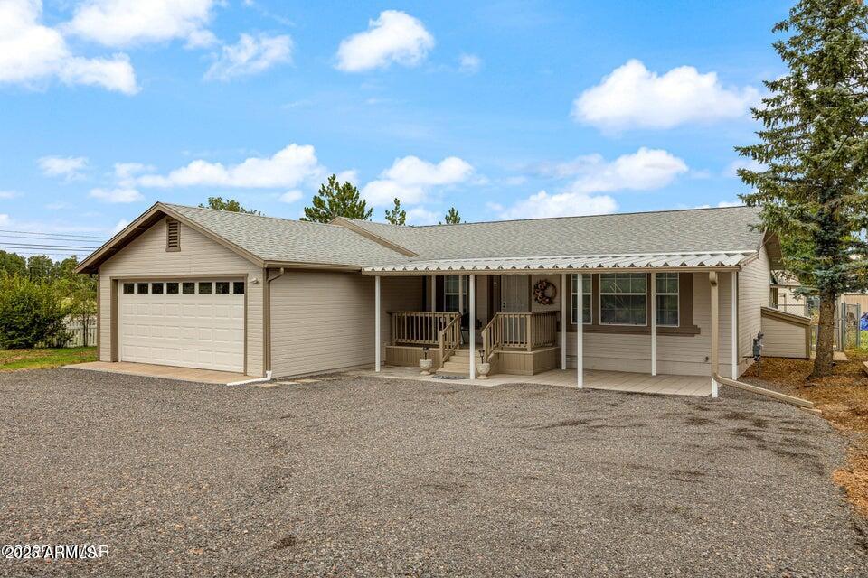 1590 Peterson Road Lakeside, AZ 85929 - Photo 21 of 41 a front view of a house with a yard and garage