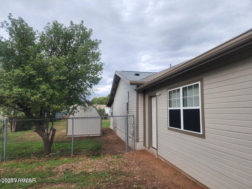 1590 Peterson Road Lakeside, AZ 85929 - Photo 23 of 41 a backyard of a house with plants and large tree
