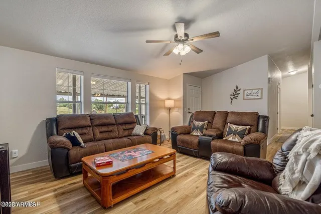 a living room with furniture a couch and window