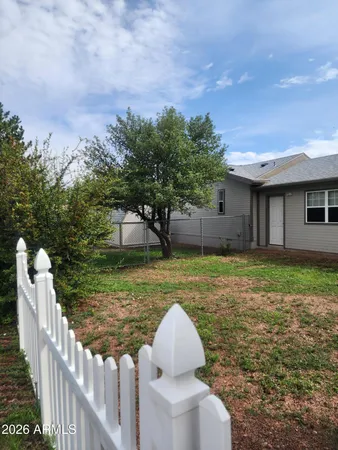 a view of a house with backyard and sitting area