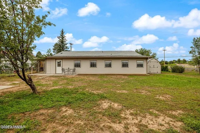 a front view of house with yard space and swimming pool