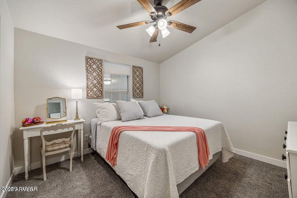 1590 Peterson Road Lakeside, AZ 85929 - Photo 9 of 41 a bed room with a bed and a chandelier