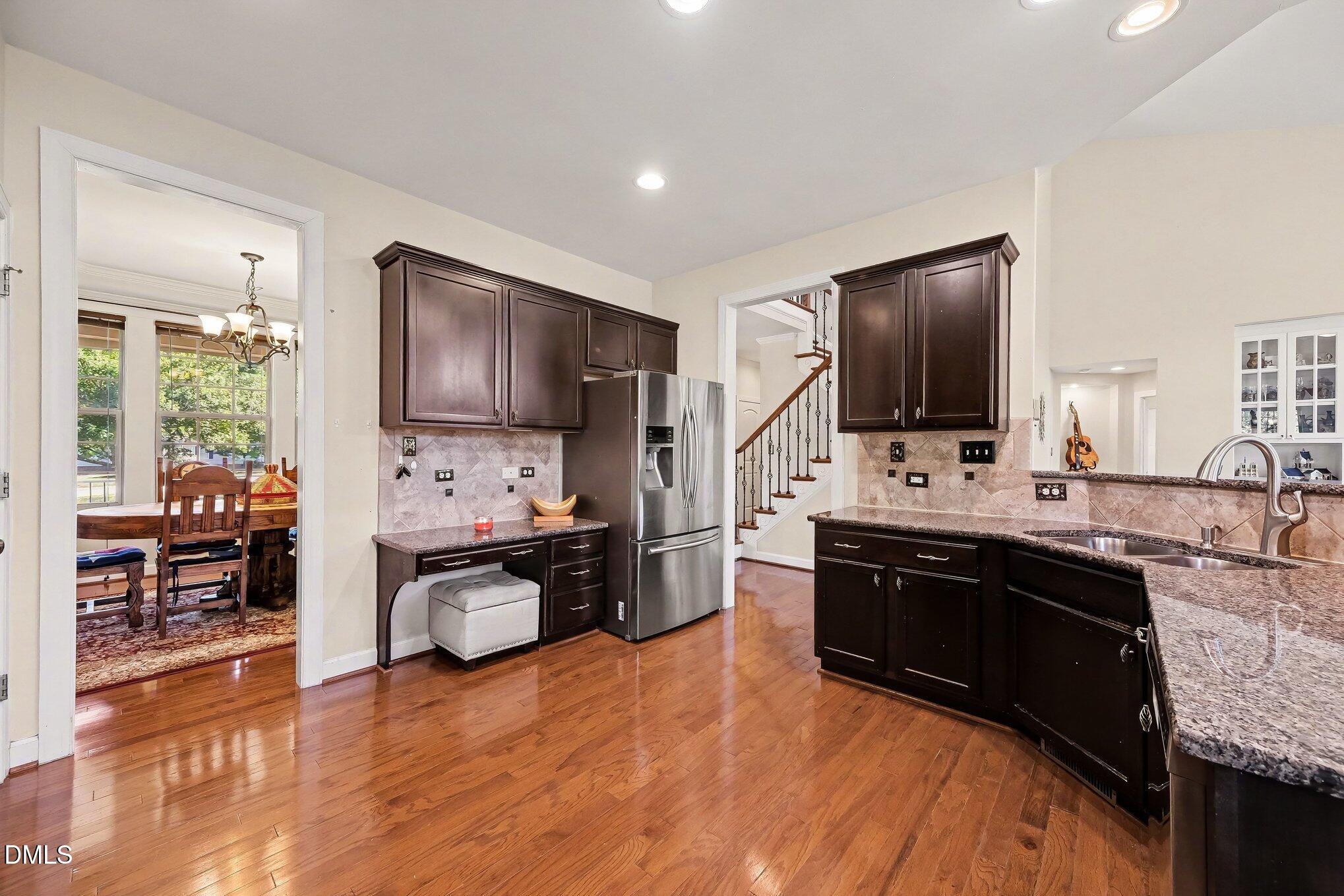 4000 Banks Stone Drive Raleigh, NC 27603 - Photo 17 of 60 a kitchen with stainless steel appliances granite countertop a sink stove and refrigerator