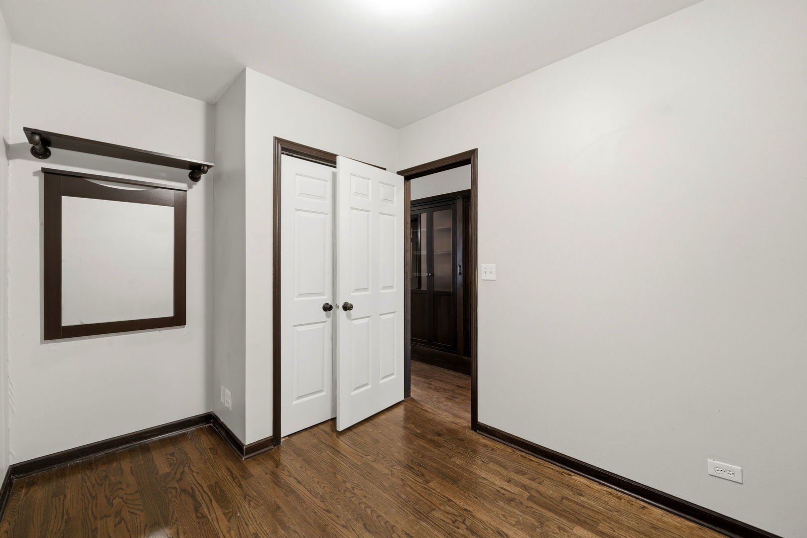 619 North Racine Avenue, Unit 1 Chicago, IL 60642 - Photo 24 of 36 a view of an empty room with wooden floor and a window