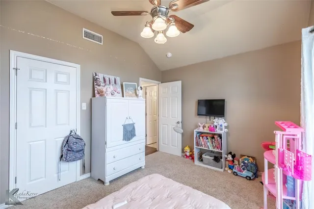 a bedroom with furniture and a flat screen tv