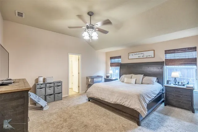 a bedroom with a bed and ceiling fan