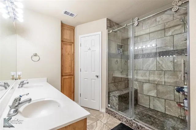 a bathroom with a shower and a sink