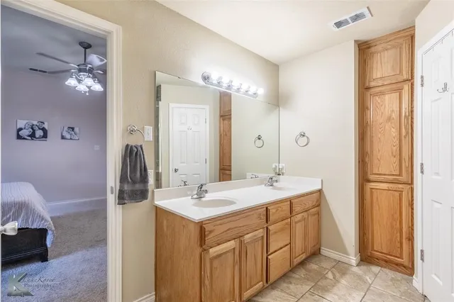 a bathroom with a sink vanity tub and shower