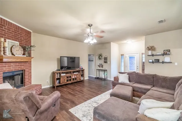 a living room with furniture fireplace and flat screen tv
