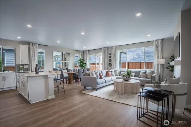a living room with fireplace furniture and a large window