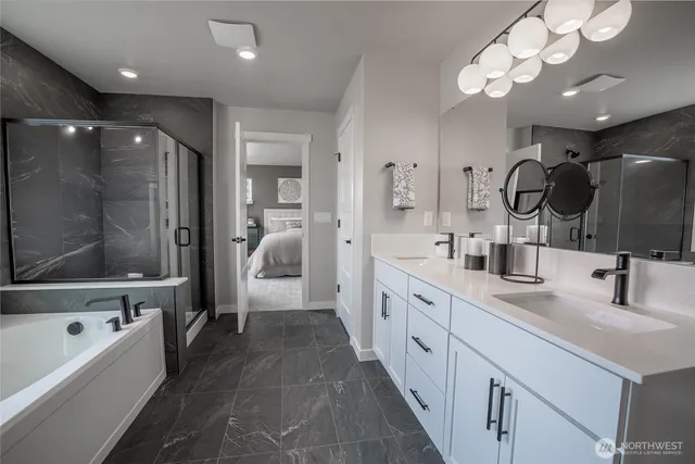 a large bathroom with a sink a large mirror and a bathtub