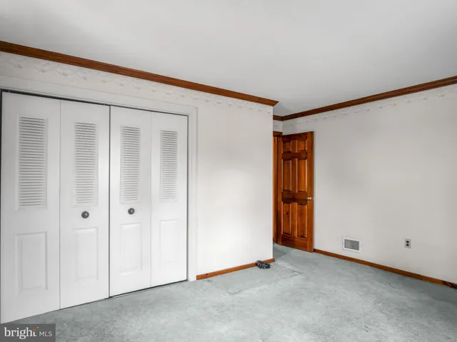 a view of a backyard with table and chairs and a large tree