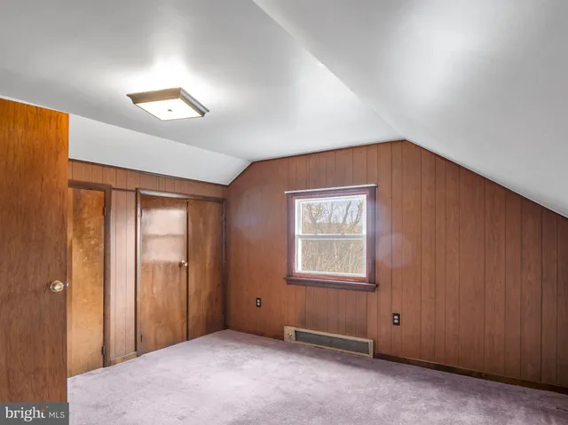 a backyard of a house with a table and chairs
