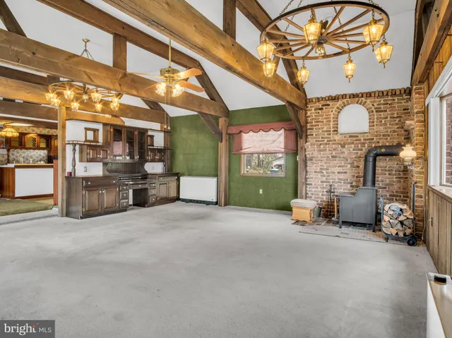 a view of an empty room with exposed radiator and fireplace