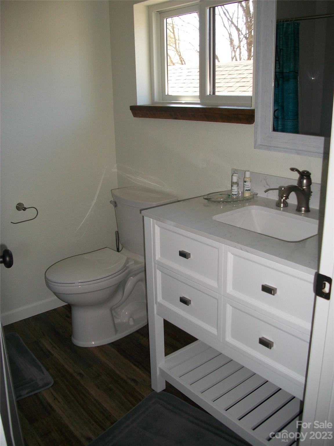 204 Mountain Spring Lane Canton, NC 28716 - Photo 18 of 18 a bathroom with a granite countertop toilet sink and mirror