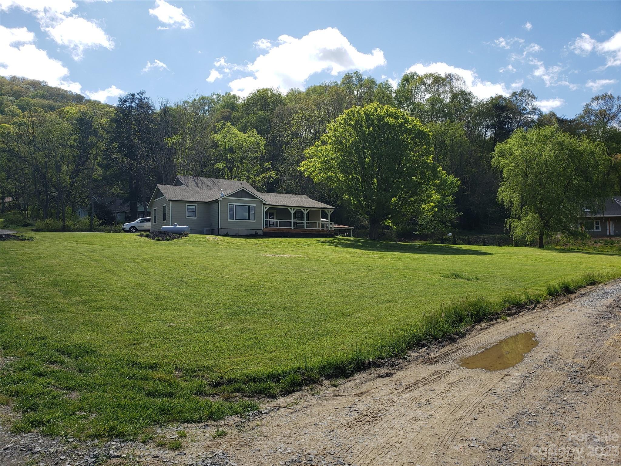 204 Mountain Spring Lane Canton, NC 28716 - Photo 3 of 18 a view of a lake with a house in the background