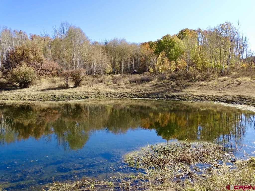 0 Groundhog Reservoir Road, Unit POND ROCK ELK & CATTLE Norwood, CO 81423 - Photo 7 of 35 a view of a lake with a mountain in the background