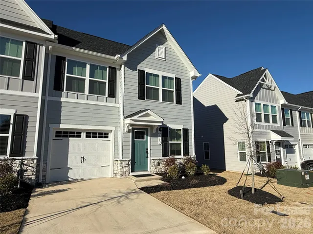 a front view of a house with parking space