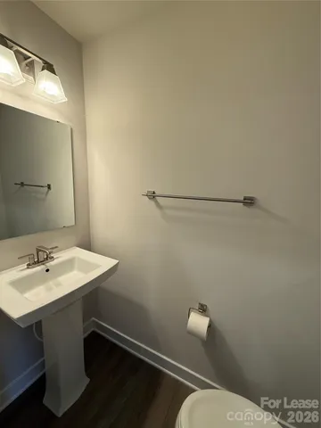a bathroom with a sink a toilet and mirror