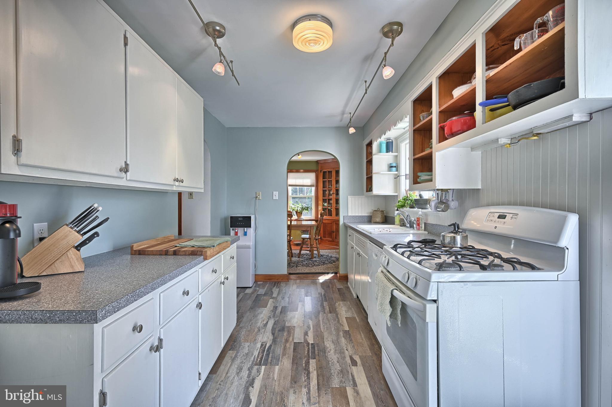 124 Market Street Lititz, PA 17543 - Photo 11 of 35 a kitchen with stainless steel appliances granite countertop a stove a sink dishwasher and cabinets with wooden floor
