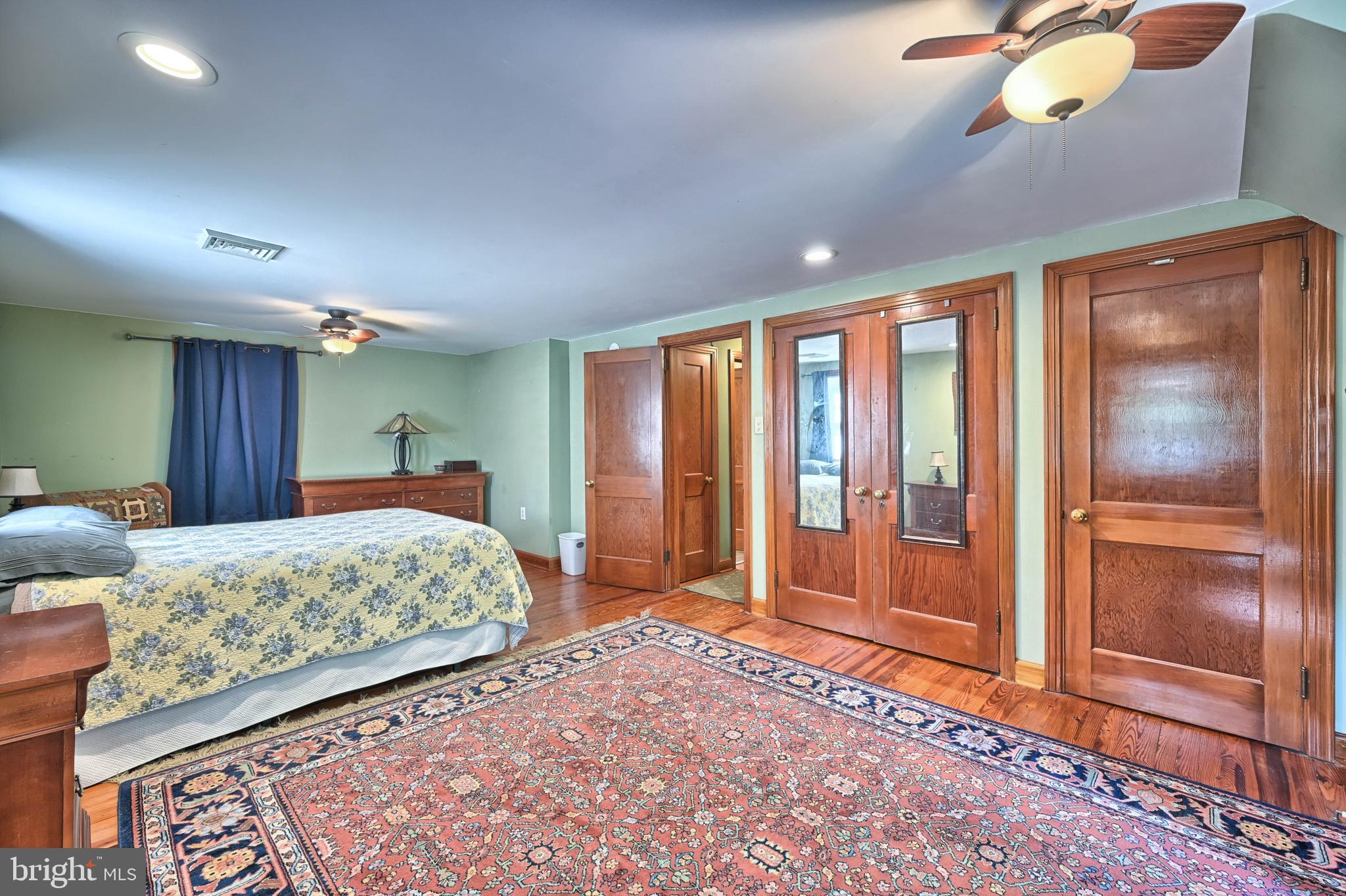 124 Market Street Lititz, PA 17543 - Photo 17 of 35 a bedroom with a large bed and chandelier