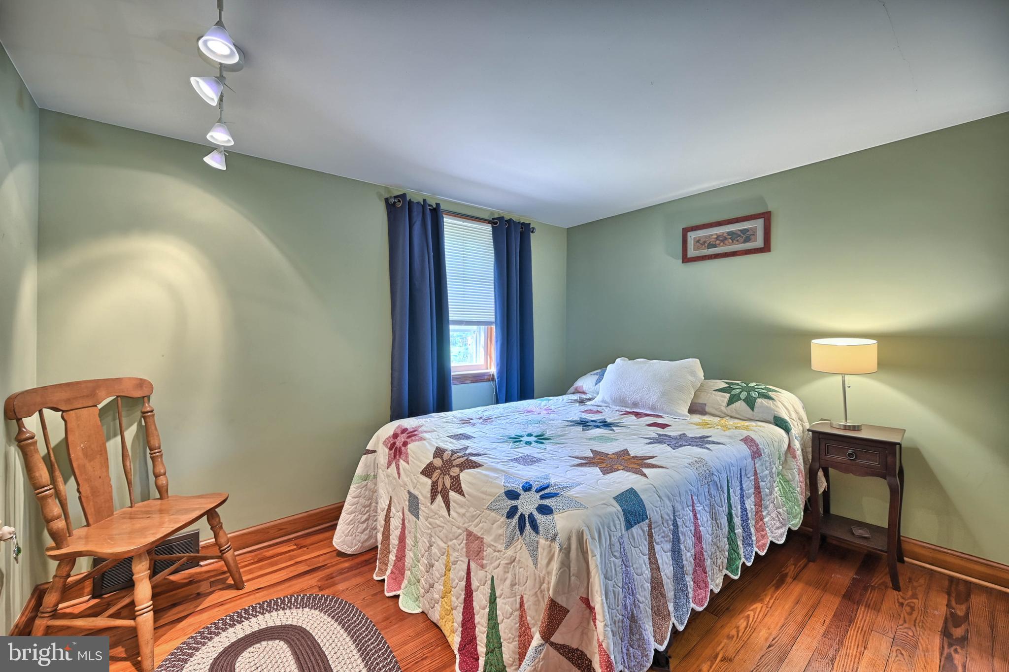 124 Market Street Lititz, PA 17543 - Photo 22 of 35 a bedroom with a bed and wooden floor