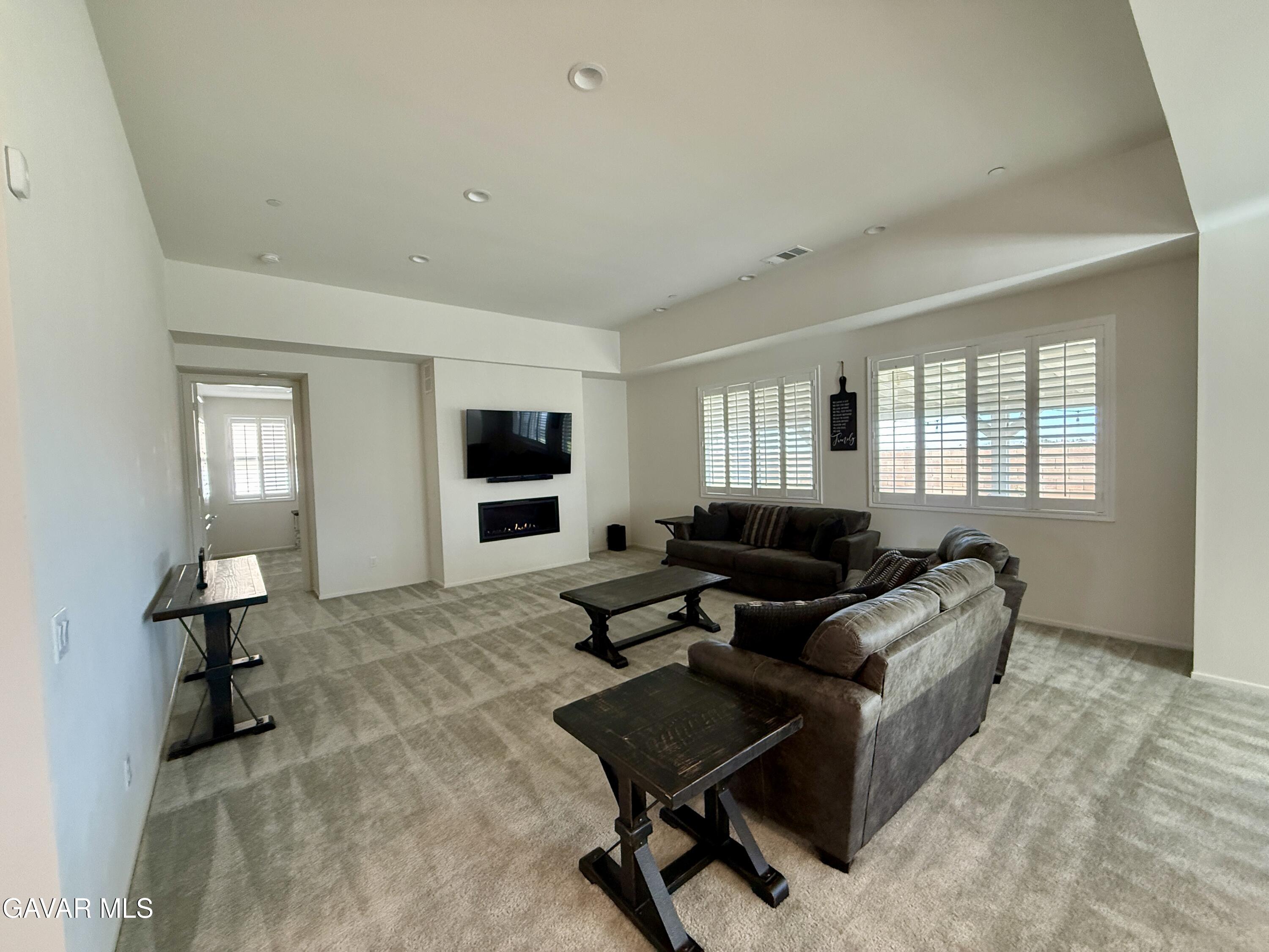 38902 Malva Rosa Drive Palmdale, CA 93551 - Photo 2 of 12 a living room with furniture and a flat screen tv