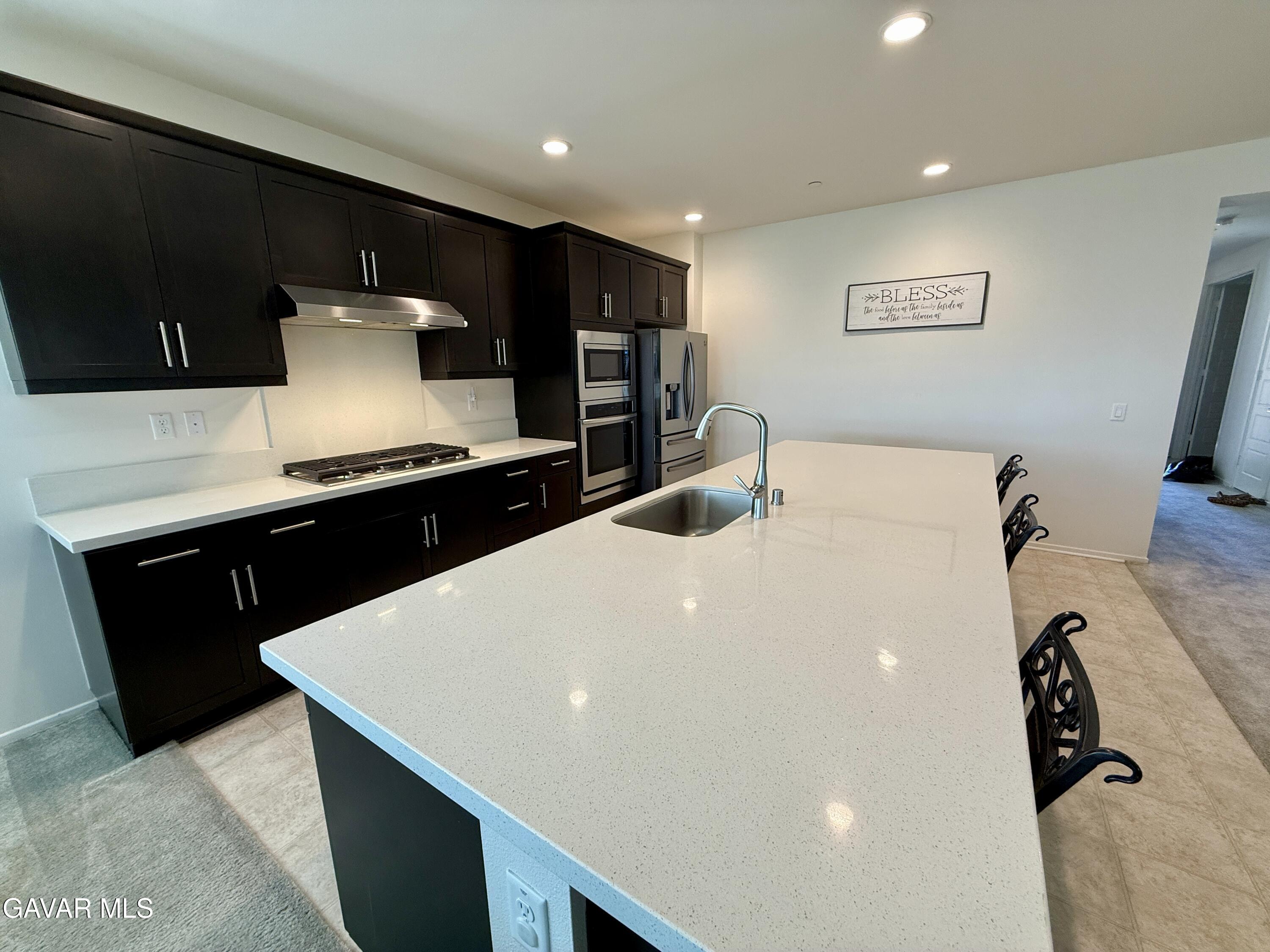 38902 Malva Rosa Drive Palmdale, CA 93551 - Photo 3 of 12 a kitchen with stainless steel appliances a sink and a refrigerator