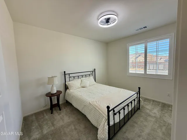 a bed room with a bed and a window