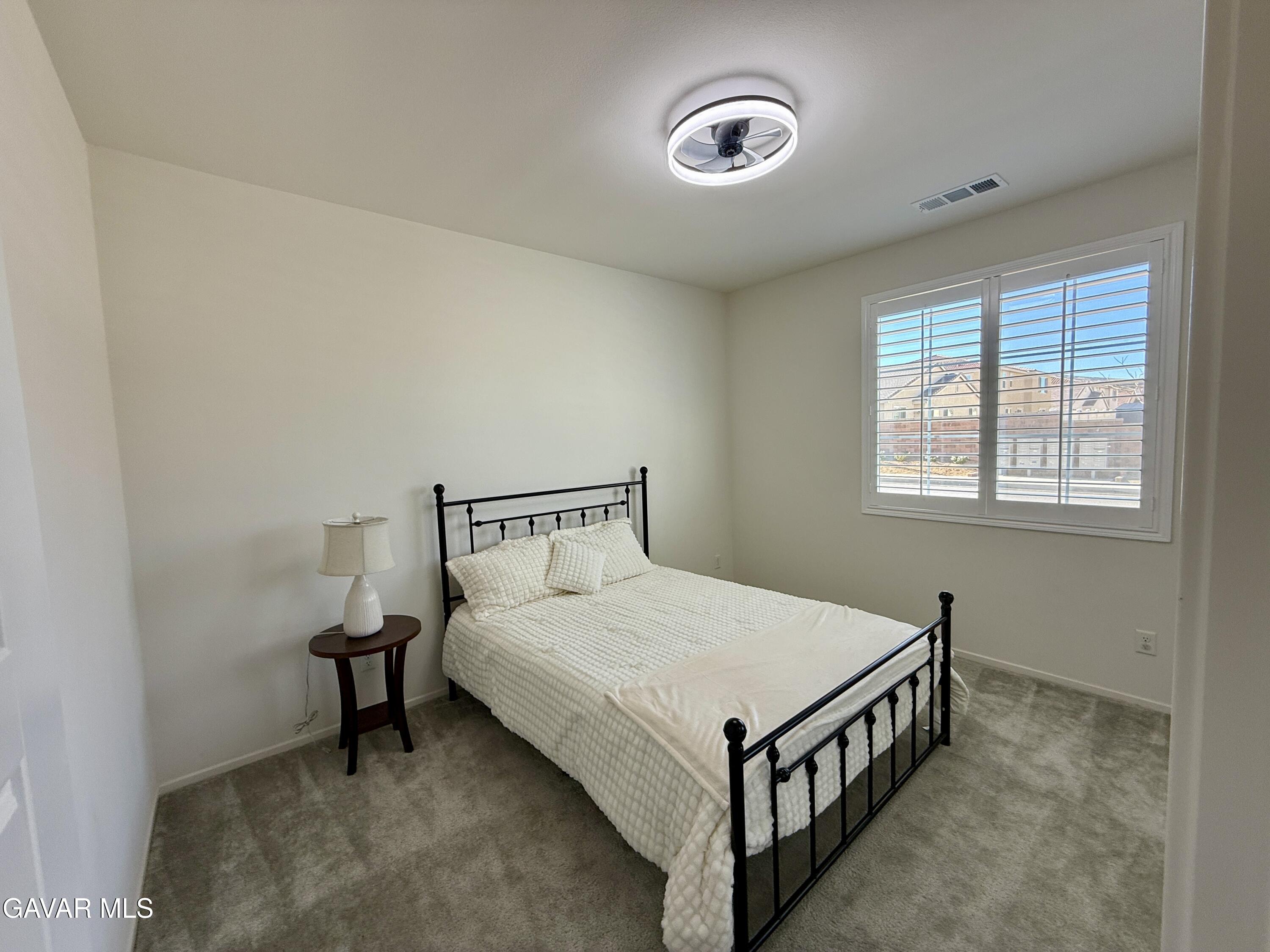 38902 Malva Rosa Drive Palmdale, CA 93551 - Photo 9 of 12 a bed room with a bed and a window