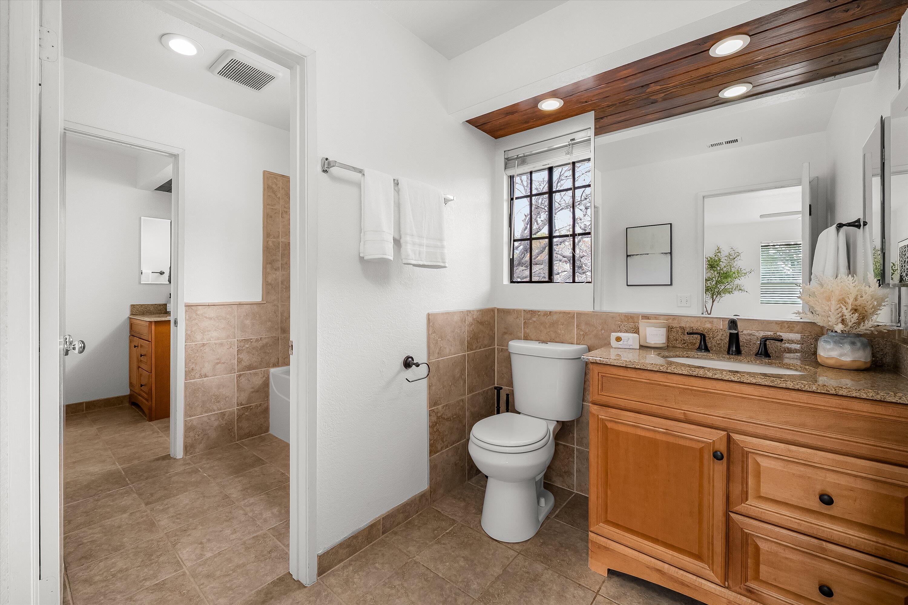 4013 Invierno Drive, Unit B Santa Barbara, CA 93110 - Photo 10 of 15 a bathroom with a toilet sink a mirror and shower