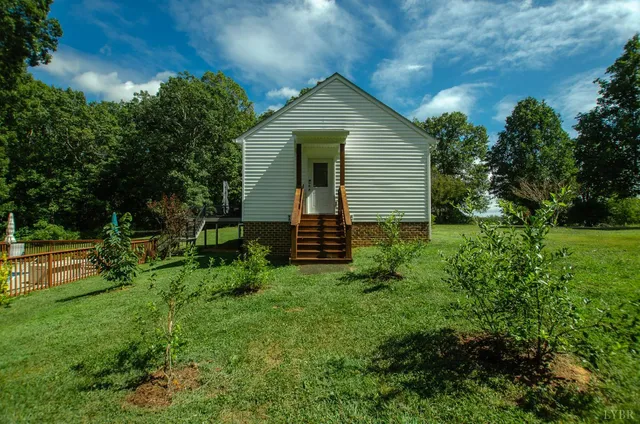a view of a house with a small yard and plants