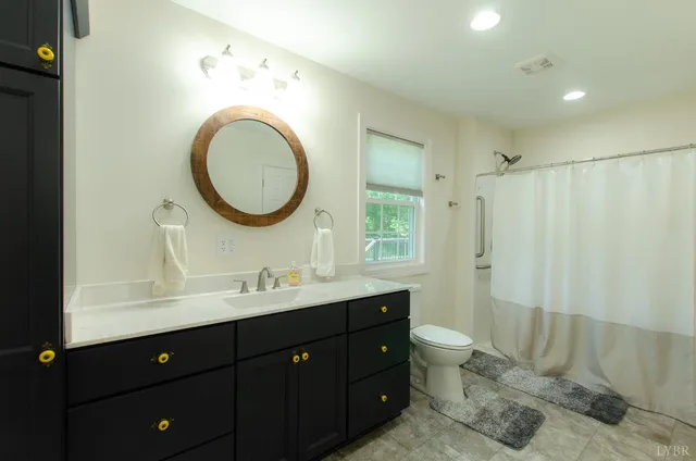 a living room with furniture and a ceiling fan