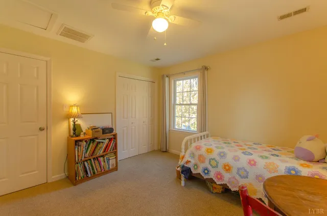 a front view of a house with a yard table and trees