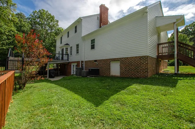 a balcony with a potted plant and outdoor seating